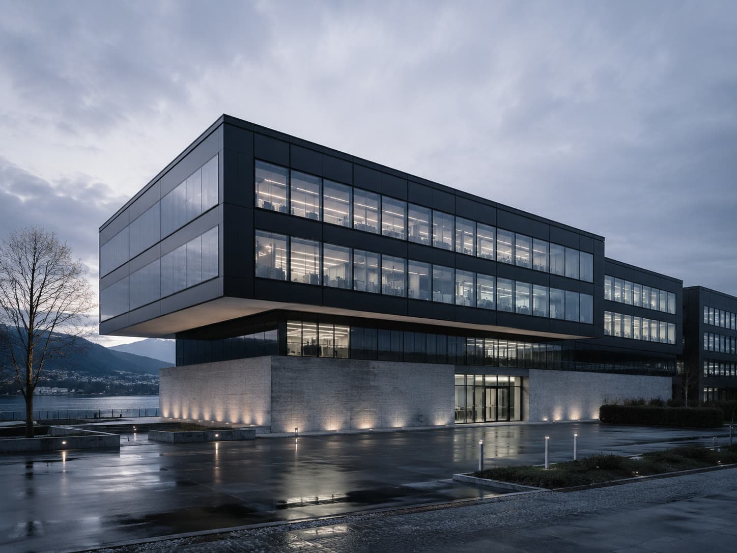 Das neue Neosilk Forschungszentrum in Zug mit dunkler Glasfassade in der Abenddämmerung